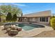 Beautiful backyard pool with rock features and brick pavers for outdoor living and entertaining at 3060 W Ironwood Cir, Chandler, AZ 85226