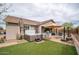 Beautiful backyard featuring a spa, manicured lawn, and an inviting outdoor dining area at 3121 N Loma Vista Dr, Mesa, AZ 85213