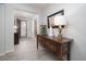 Entryway with wood flooring, decorative console table, lamp, and picture frame at 3121 N Loma Vista Dr, Mesa, AZ 85213