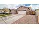 Single-Gathering home with a two-car garage, side yard gate, and concrete driveway at 3121 N Loma Vista Dr, Mesa, AZ 85213