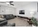 Comfortable living room featuring a leather sectional sofa, large TV, and plantation shutters at 3121 N Loma Vista Dr, Mesa, AZ 85213