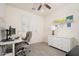 Bright home office featuring a ceiling fan, modern desk, and white shuttered window, perfect for remote work at 3121 N Loma Vista Dr, Mesa, AZ 85213