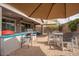 Outdoor patio boasts built-in kitchen with grill, dining set, seating area, and large shade umbrellas providing an outdoor retreat at 3121 N Loma Vista Dr, Mesa, AZ 85213