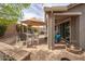 Brick patio with an outdoor kitchen and bar, dining set, seating and shade umbrellas to provide the perfect setting at 3121 N Loma Vista Dr, Mesa, AZ 85213