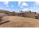 The large, blank canvas backyard is enclosed by a chainlink fence at 345 N Madison St, Wickenburg, AZ 85390