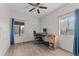 Relaxing bedroom with hardwood floors, bright windows, and a ceiling fan at 345 N Madison St, Wickenburg, AZ 85390