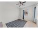 Bright bedroom features neutral walls, tile flooring, a ceiling fan, and a window at 345 N Madison St, Wickenburg, AZ 85390