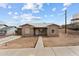 Charming single-story home features a neutral exterior, updated roof, and sidewalk at 345 N Madison St, Wickenburg, AZ 85390