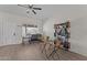 Neutral room with ceiling fan, wood-look flooring, shelf, table, and natural light at 345 N Madison St, Wickenburg, AZ 85390