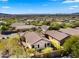 An aerial view reveals a backyard with a covered patio and desert landscaping in a residential area at 3708 W Rushmore Dr, Anthem, AZ 85086