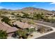 Expansive aerial view showcases a single-Gathering home in a desert neighborhood with mountain views at 3708 W Rushmore Dr, Anthem, AZ 85086