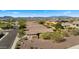 Scenic aerial view showcases houses in a desert community with views of surrounding mountains at 3708 W Rushmore Dr, Anthem, AZ 85086