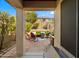 Inviting covered patio boasts brick pavers, outdoor seating, a grill, and views of the landscaped yard at 3708 W Rushmore Dr, Anthem, AZ 85086