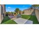 An expansive backyard shows a green lawn, patio with furniture, and privacy wall for outdoor enjoyment at 3708 W Rushmore Dr, Anthem, AZ 85086