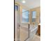 Relaxing bathroom featuring a separate tub and shower, complemented by natural light from the windows at 3708 W Rushmore Dr, Anthem, AZ 85086