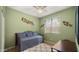 A bright bedroom with a daybed, neutral walls, a ceiling fan, and natural light from the window at 3708 W Rushmore Dr, Anthem, AZ 85086