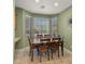 This dining nook features three windows, natural light, a wood table, and six chairs at 3708 W Rushmore Dr, Anthem, AZ 85086