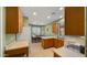 Bright kitchen view, with oak cabinets, tiled floors, modern white appliances, and a view into the dining room at 3708 W Rushmore Dr, Anthem, AZ 85086