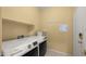 This spacious laundry room features a modern washer and dryer and a security system at 3708 W Rushmore Dr, Anthem, AZ 85086