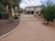 A well manicured backyard with ample gravel and rock ground cover, trees, and plantings, along with access to covered patio at 40232 W Marion May Ln, Maricopa, AZ 85138