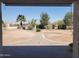Expansive backyard featuring mature landscaping, a stone walkway, and plenty of space for outdoor activities and relaxation at 40232 W Marion May Ln, Maricopa, AZ 85138
