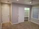 Carpeted bedroom with sliding door closet and window at 40232 W Marion May Ln, Maricopa, AZ 85138
