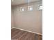 The bedroom features wood laminate flooring, neutral colored walls and bright white trim at 40232 W Marion May Ln, Maricopa, AZ 85138