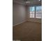 Spacious bedroom featuring neutral carpet, and natural light from the bright windows at 40232 W Marion May Ln, Maricopa, AZ 85138