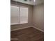 Bedroom features wood laminate flooring, neutral colored walls and bright white trim at 40232 W Marion May Ln, Maricopa, AZ 85138