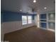 Large bedroom features custom shelves with accent lighting, carpet and neutral colored walls at 40232 W Marion May Ln, Maricopa, AZ 85138