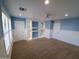 Large bedroom features custom shelves with accent lighting, carpet and neutral colored walls at 40232 W Marion May Ln, Maricopa, AZ 85138