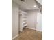 Carpeted walk-in closet with built-in shelving and hanging rod at 40232 W Marion May Ln, Maricopa, AZ 85138