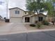 Two-story house featuring stucco exterior, three car garage, desert landscaping, and a curved driveway at 40232 W Marion May Ln, Maricopa, AZ 85138