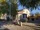 Rear view of the two-story home showing desert landscaping at 40232 W Marion May Ln, Maricopa, AZ 85138