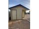 Exterior view of shed featuring neutral paint, dark trim, and concrete pavers at 40232 W Marion May Ln, Maricopa, AZ 85138