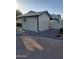 Exterior shot of shed showing neutral paint, dark trim, and gravel landscaping at 40232 W Marion May Ln, Maricopa, AZ 85138