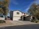 Charming two-story home with a three-car garage and low maintenance desert landscaping at 40232 W Marion May Ln, Maricopa, AZ 85138