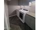 Laundry room with gray cabinets, updated countertops and modern washer and dryer at 40232 W Marion May Ln, Maricopa, AZ 85138