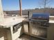 Built-in outdoor kitchen with stainless steel grill and storage at 40232 W Marion May Ln, Maricopa, AZ 85138