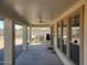 Spacious covered patio featuring a ceiling fan, outdoor kitchen, and access to a beautiful outdoor space at 40232 W Marion May Ln, Maricopa, AZ 85138
