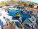 Aerial view of a large community pool with gazebos, lounge chairs and desert landscaping at 40232 W Marion May Ln, Maricopa, AZ 85138