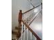 Carpeted staircase with wood and white painted railings and balusters at 40232 W Marion May Ln, Maricopa, AZ 85138