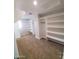 Large walk-in closet featuring custom shelving and ample storage space at 40232 W Marion May Ln, Maricopa, AZ 85138