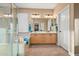 Well-lit bathroom with double vanity, walk-in shower, and soaking tub for spa-like comfort at 41006 N Noble Hawk Way, Anthem, AZ 85086