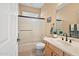 Clean bathroom with a shower-tub combo, single vanity, and neutral color palette at 41006 N Noble Hawk Way, Anthem, AZ 85086