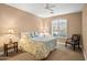 Inviting bedroom featuring a queen bed, shuttered windows, neutral tones, and carpet flooring at 41006 N Noble Hawk Way, Anthem, AZ 85086