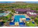 Community pool and water park with various pools, slides, and seating areas, surrounded by lush greenery and mountain views at 41006 N Noble Hawk Way, Anthem, AZ 85086