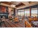 Elegant dining room featuring ample seating, a fireplace, and views of the golf course at 41006 N Noble Hawk Way, Anthem, AZ 85086