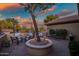 Relaxing patio with comfortable seating surrounding a mature tree, with decorative pavers at 41006 N Noble Hawk Way, Anthem, AZ 85086