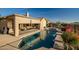 Beautiful outdoor pool area with covered patio seating and desert landscaping at 41006 N Noble Hawk Way, Anthem, AZ 85086